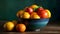 Various orange fruit in a ceramic bowl in a table