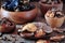 Various organic dried Chinese mushrooms in a wooden bowl on the old wooden background.