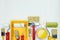 various paint brushes, rollers, paint cans and paint tray on white wooden background