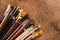 Various paintbrushes collection on brown wooden table