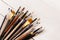 Various paintbrushes collection on wooden table