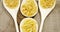 Various pasta in spoons on wooden background