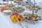 Various pastries and fruits displayed on silver trays