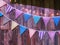 Various Patterned Triangular Flags with Lighting String on Wooden Planks Background