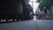 Various people walk along paved platform past standing train