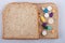 Various pills, tablets and capsules of medicine filling in bread sandwich layer