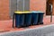 Various plastic garbage containers with colored lids for environmentally friendly sorting of garbage for recycling with full