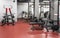Various powerlifting equipment in spacious, well lit, empty gym interior. Special modern exercise machines for physical