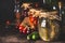 Various preserved fermented seasonal vegetables and fruits from garden in glass jars on dark rustic background, close up. Autumn