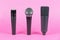 Various professional microphones on pink background