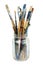 Various professional paint brushes in the transparent jar