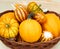 Various pumpkins, melons and corn in wattled basket