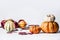 Various pumpkins on white background with fall leaves, front view. Autumn vegetables , Thanksgiving food