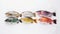 Various raw fish in a row, white background. Seafood assortment, menu. AI generated.