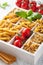 Various raw wholegrain pasta in white wooden box