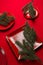 Various red plates on a red tablecloth with Christmas tree branches on the table