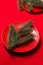 Various red plates on a red tablecloth with Christmas tree branches on the table