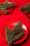 Various red plates on a red tablecloth with Christmas tree branches on the table