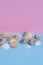 Various seashells on a light blue and pink background with different views and lots of copyspace