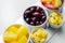 Various set fruits, pineapple, apple, grapes with matured cheddar cheese in bowls