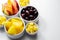 Various set fruits, pineapple, apple, grapes with matured cheddar cheese in bowls