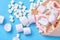 Various shapes of marshmallows wrapped in paper on a blue background,