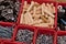 Various size and shape of screws, bolts, wooden pegs selection in red plastic tray box on a wooden background. Assembly kit for fu