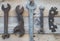 Various size spanners, wrenches on wooden background, colorised