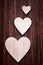 Various sized wooden hearts placed on a vintage wood