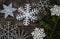 various snowflake shapes on wooden ground with yew branch