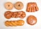 Various specialty donuts on parchment paper, flat lay