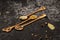 Various spice mixes in wooden spoons on black stone background. Selective focus