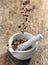 Various spices falling into mortar and pestle