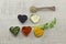 Various spices in heart chaped containers on a tablecloth