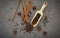 Various of spices and herbs in wooden spoons. Flat lay spices ingredients clove ,peppercorn, cinnamon and star anise on dark stone