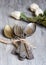 Various spoons and forks entwined on rustic wooden table