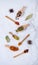 Various spoons of oriental spices on marble background