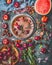 Various summer berries and fruits on rustic aged kitchen table with flowers and plates, top view, flat lay