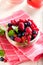 Various summer fruits in a bowl. Assorted fresh berries with lea