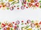 Various summer tropical fruits slices frame on white background, top view, flat layout