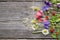 Various summer wild flowers on wooden background