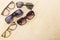 Various sunglasses set on yellow wooden background.