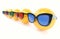 Various sunglasses on yellow dummy balls with colorful lenses.