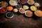 Various superfoods in smal bowls on dark rusty background