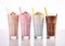 Various taste and color creamy milkshake glasses on white.Macro.AI Generative