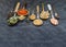 Various teas and dried herbs assortment on spoons in rustic style on balck background
