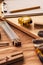 Various tools on carpentry woodwork workshop desk, selective focus