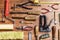 Various tools for repair: pliers, drills, rollers, hammer on a wooden background