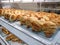 Various type of sweet buns displays on display rack in the bakery shop.