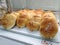 Various type of sweet buns displays on display rack in the bakery shop.